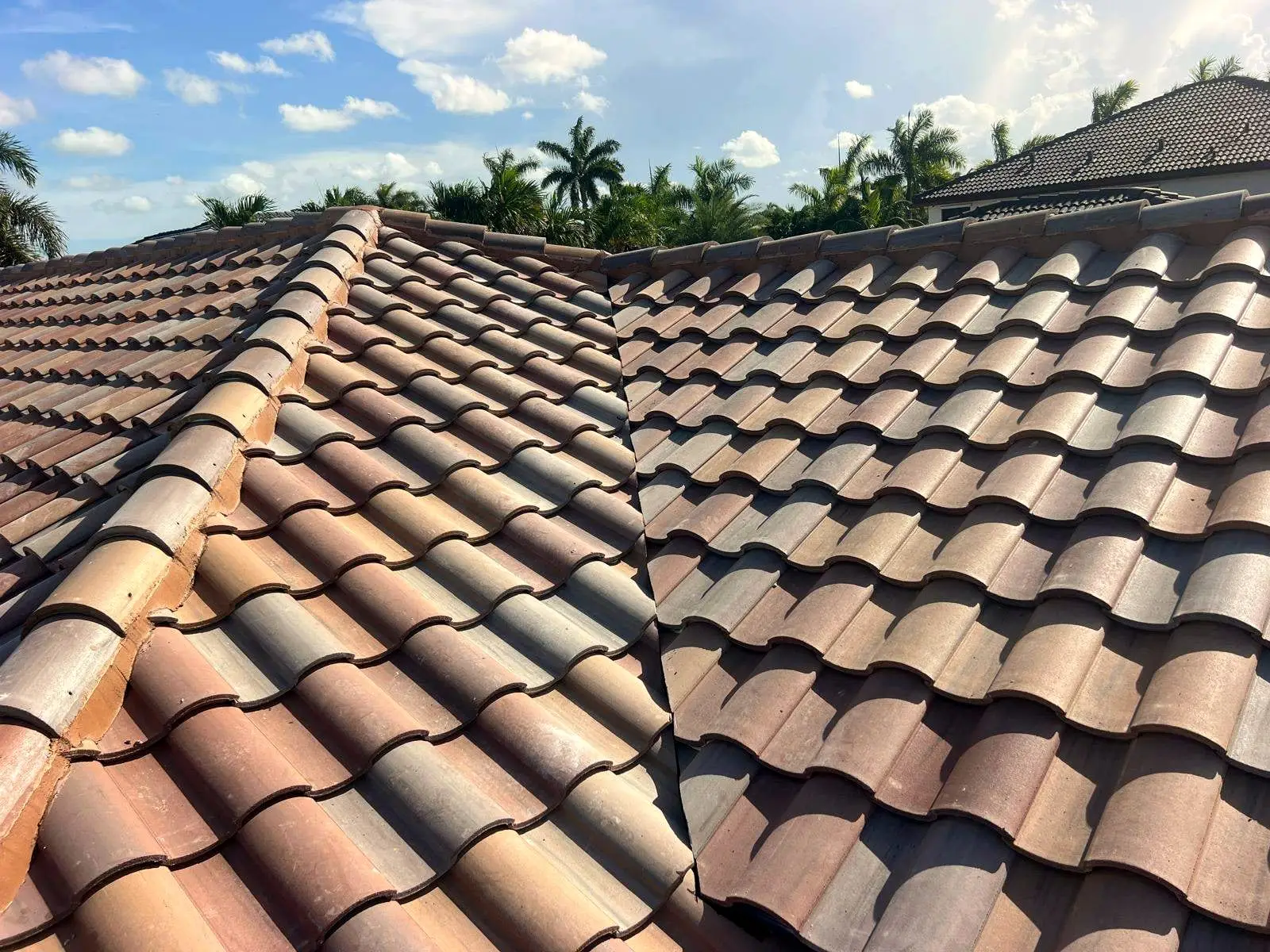 Finished barrel tile courses meeting along a roof hip