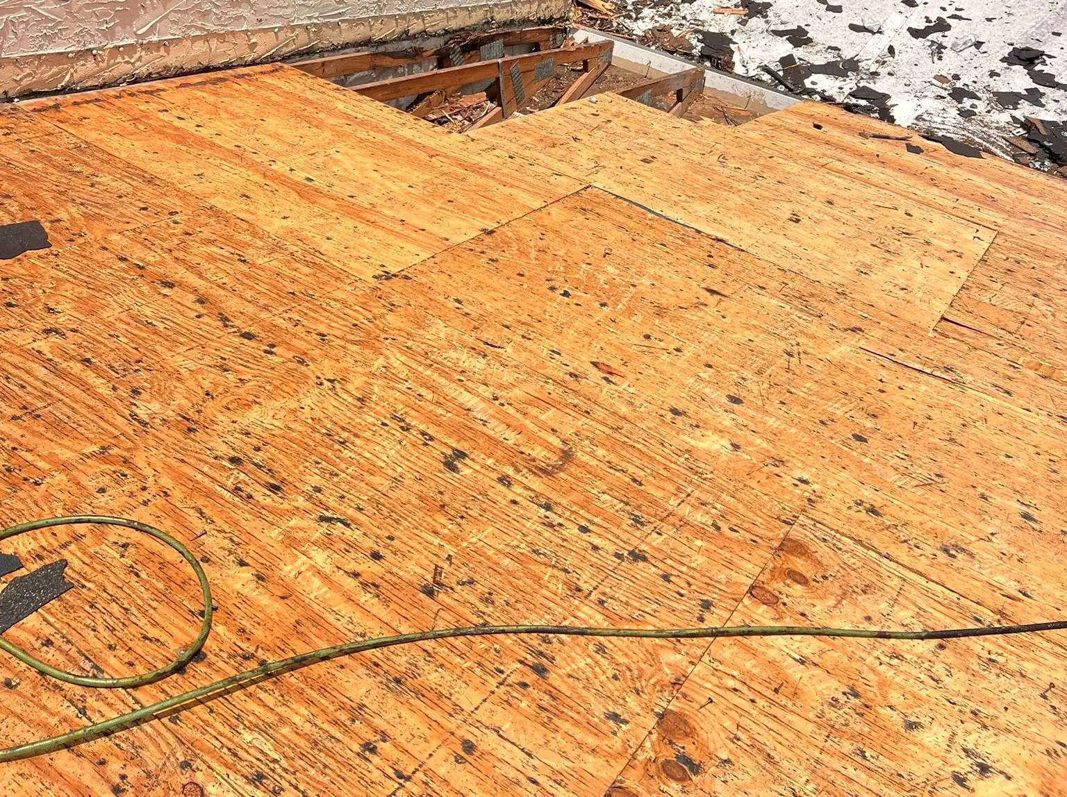 New plywood sheathing fastened over a roof deck
